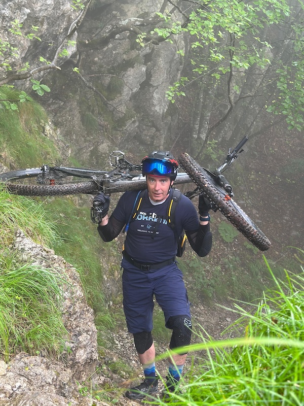 Carrying my bike on my shoulders up a steep rocky hill