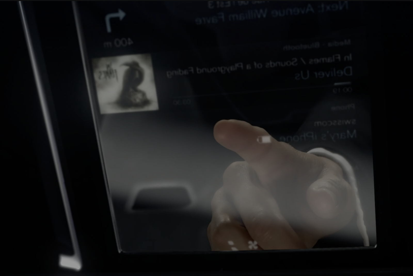 Screenshot from the linked video, showing a finger touching teh dashboard screen
