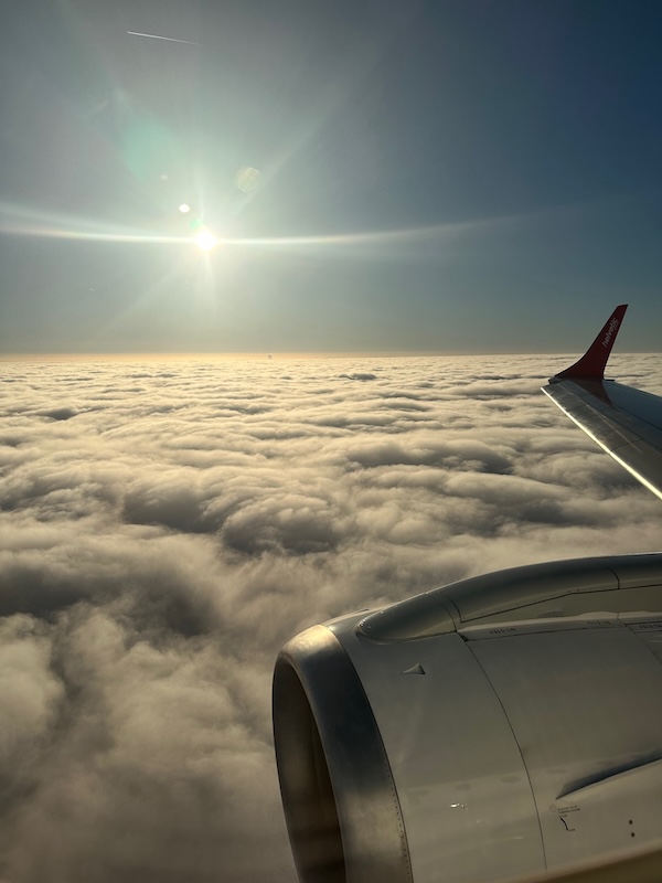 Aeroplane wing about to dip below the clouds